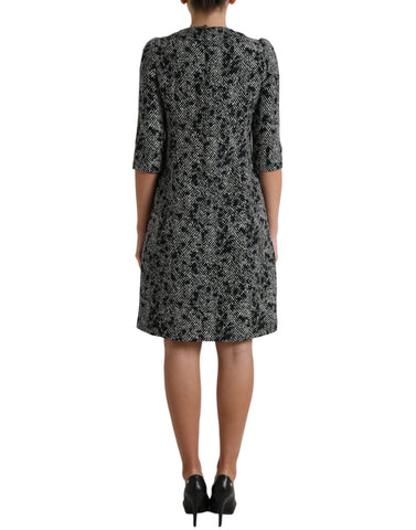 Black chevron polyester shift mini dress by Dolce & Gabbana, featuring a stylish fitted silhouette and bold geometric pattern.