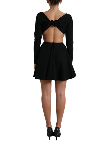 Black viscose cut-out A-line mini dress with long sleeves by Dolce & Gabbana, shown on a model in a stylish pose.