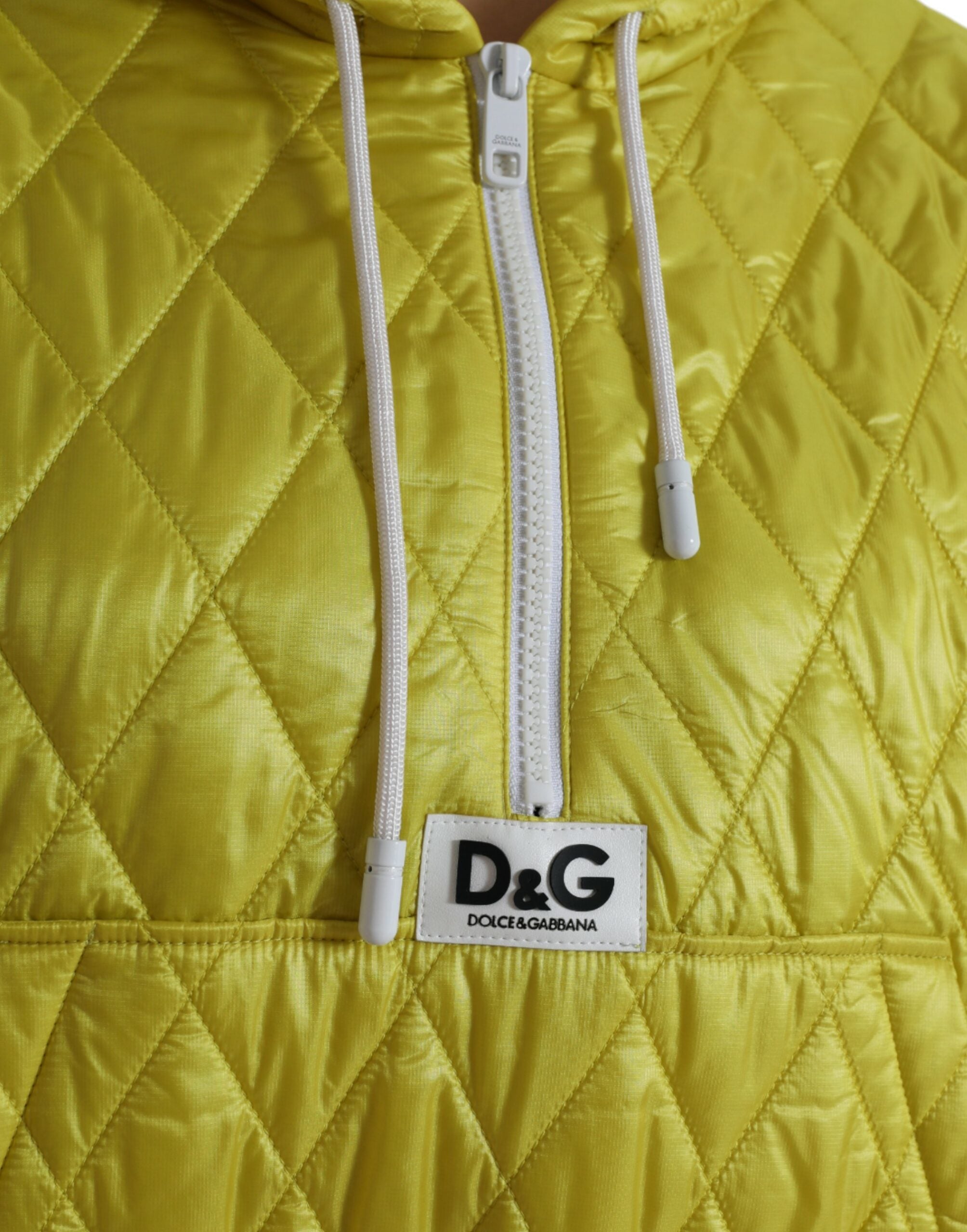 Yellow nylon quilted hooded pullover jacket by Dolce & Gabbana with a padded design and drawstring hood.