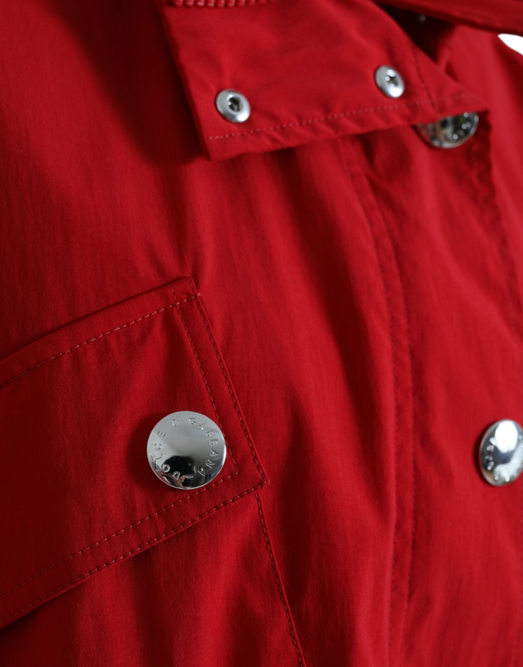 Red polyester hooded rain coat with button closure by Dolce & Gabbana, featuring a stylish waterproof jacket for rainy days.