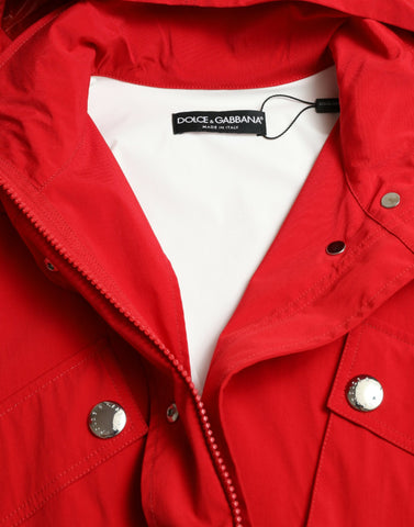 Red polyester hooded rain coat jacket with button closure by Dolce & Gabbana, shown hanging open with a hood and front pockets.