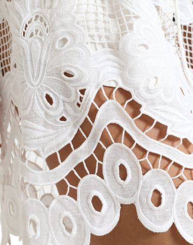 White cotton high-waist Bermuda shorts with cutout details from Dolce & Gabbana, displayed on a neutral background.