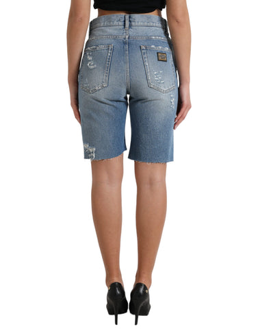 Blue tattered embellished Bermuda shorts by Dolce & Gabbana with decorative details and distressed fabric, styled for casual wear.