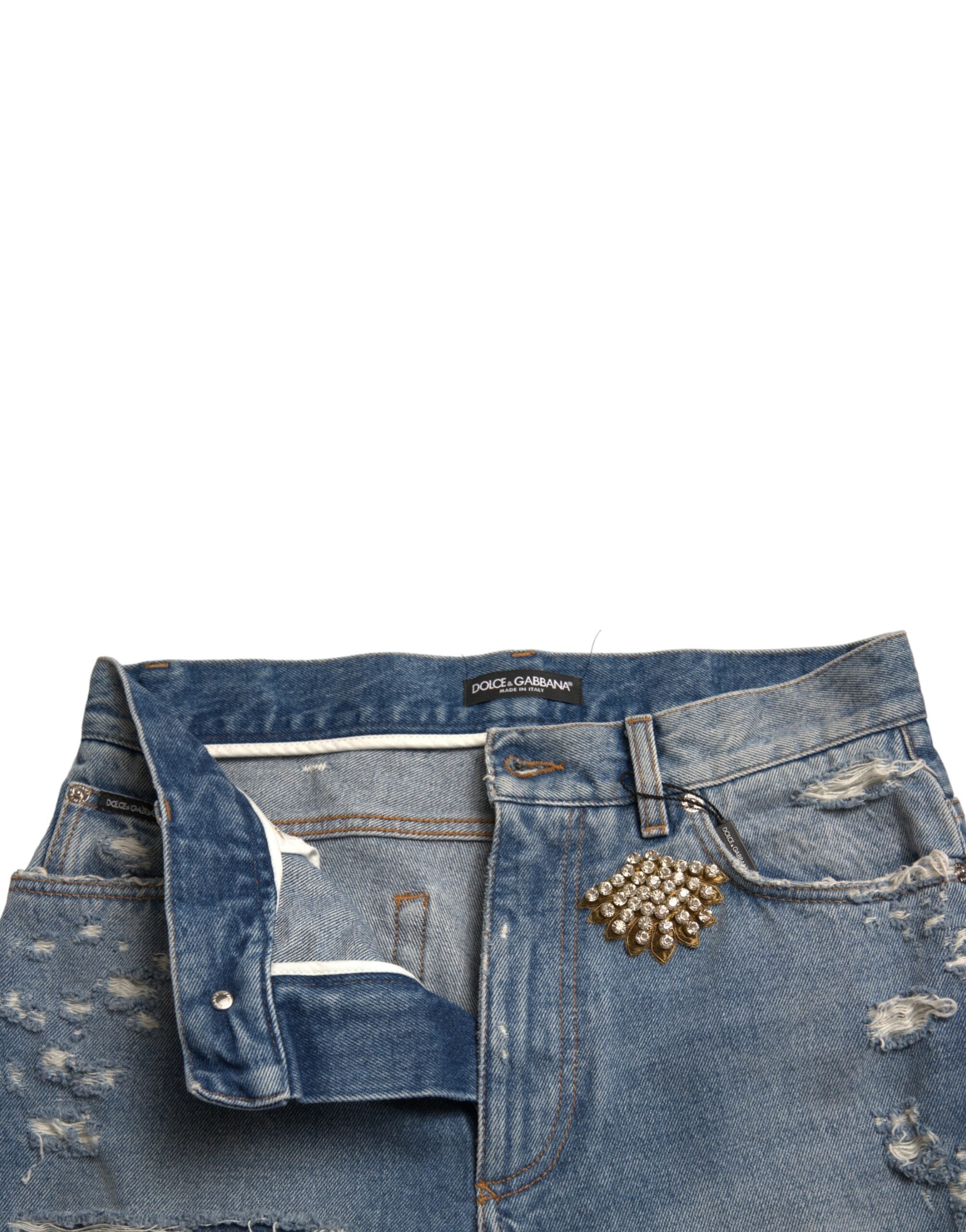 Blue tattered embellished Bermuda shorts by Dolce & Gabbana with decorative details and frayed edges, casual summer style.