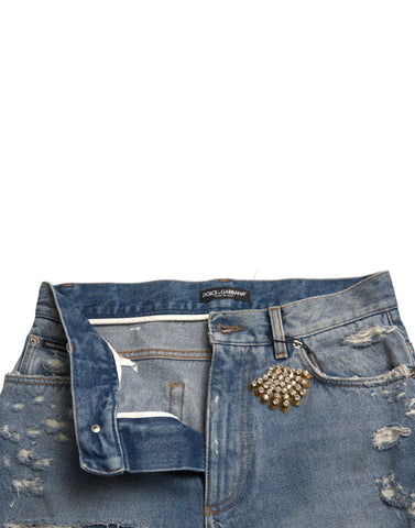 Blue tattered embellished Bermuda shorts by Dolce & Gabbana with decorative details and frayed edges, casual summer style.