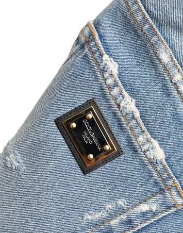 Blue tattered embellished Bermuda shorts by Dolce & Gabbana with distressed details and decorative embellishments.