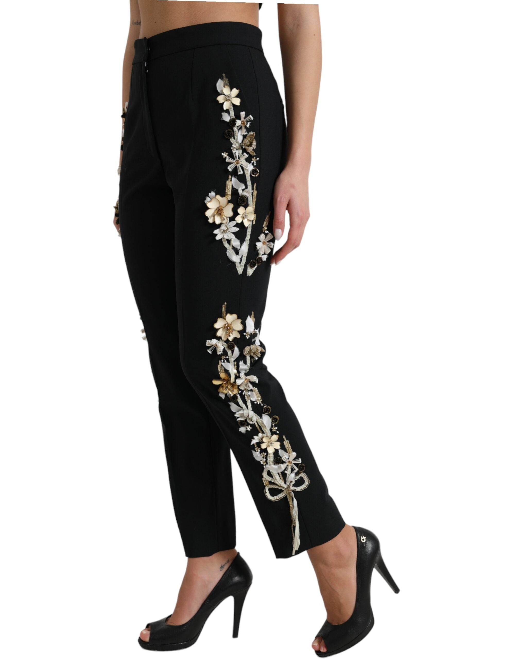 Black floral applique high waist tapered pants by Dolce & Gabbana with tailored fit and intricate floral embroidery.
