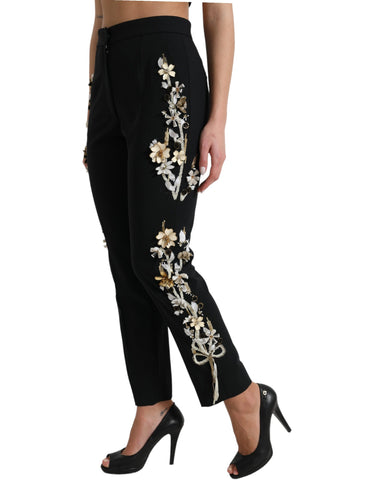 Black floral applique high waist tapered pants by Dolce & Gabbana with tailored fit and intricate floral embroidery.