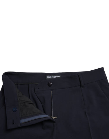 Blue mid waist tapered cropped pants by Dolce & Gabbana, showing the fitted waistband and stylish tapered leg design.
