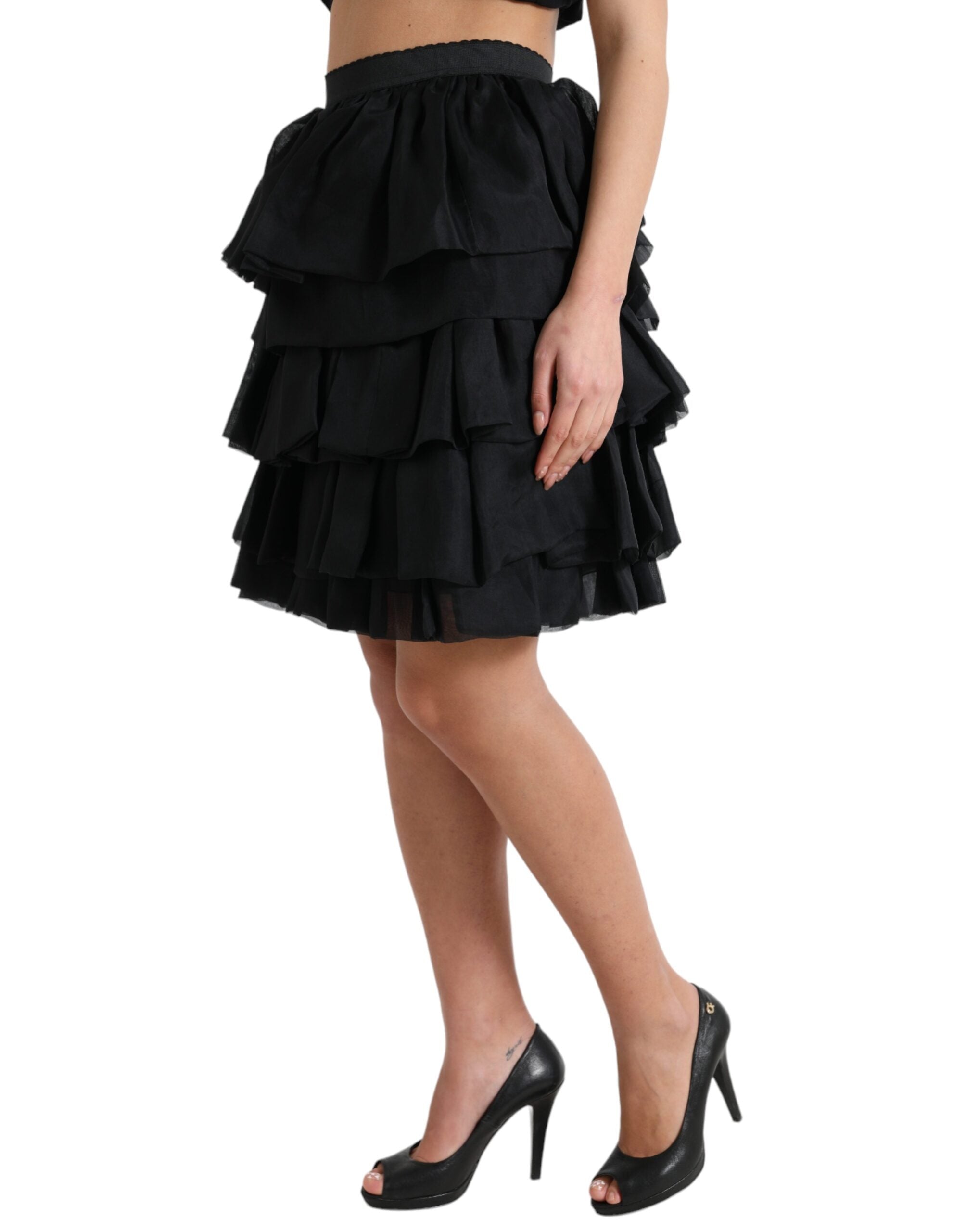 Black tiered A-line high waist silk mini skirt by Dolce & Gabbana, showcasing a stylish layered design and smooth fabric.