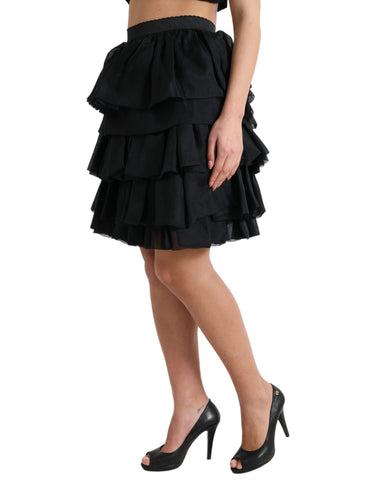 Black tiered A-line high waist silk mini skirt by Dolce & Gabbana, showcasing a stylish layered design and smooth fabric.
