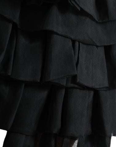 Black tiered A-line silk mini skirt with high waist from Dolce & Gabbana, shown on a model with a flowy, elegant design.