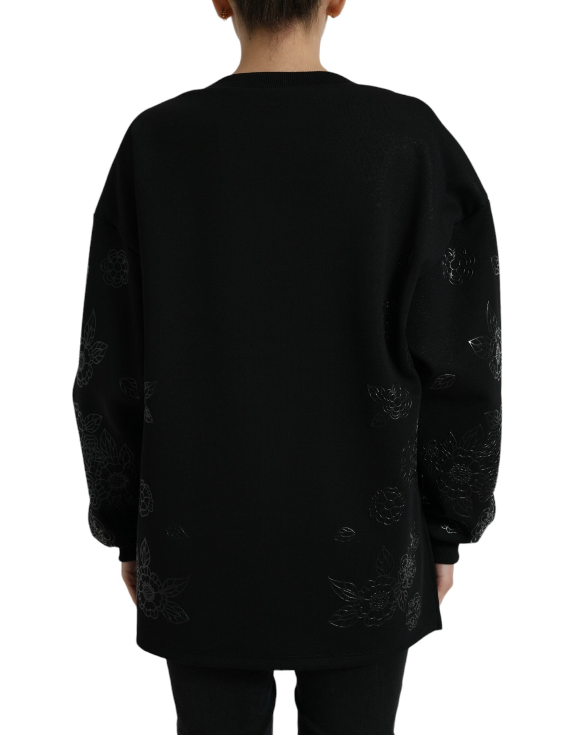 Black Dolce & Gabbana pullover sweater with floral logo applique and crew neck, shown on a model.