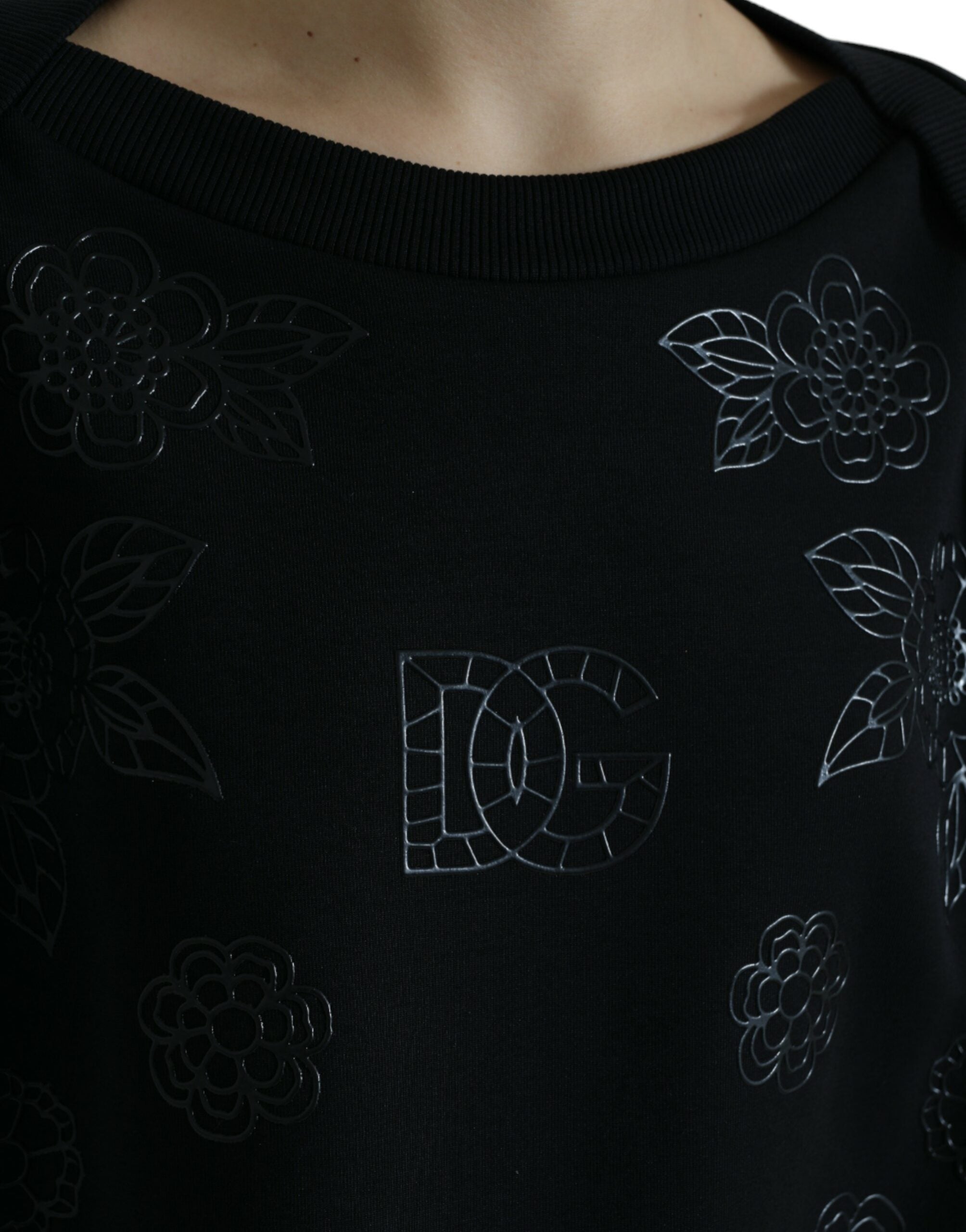 Black Dolce & Gabbana pullover sweater with floral logo applique, featuring a cozy knit and stylish design.
