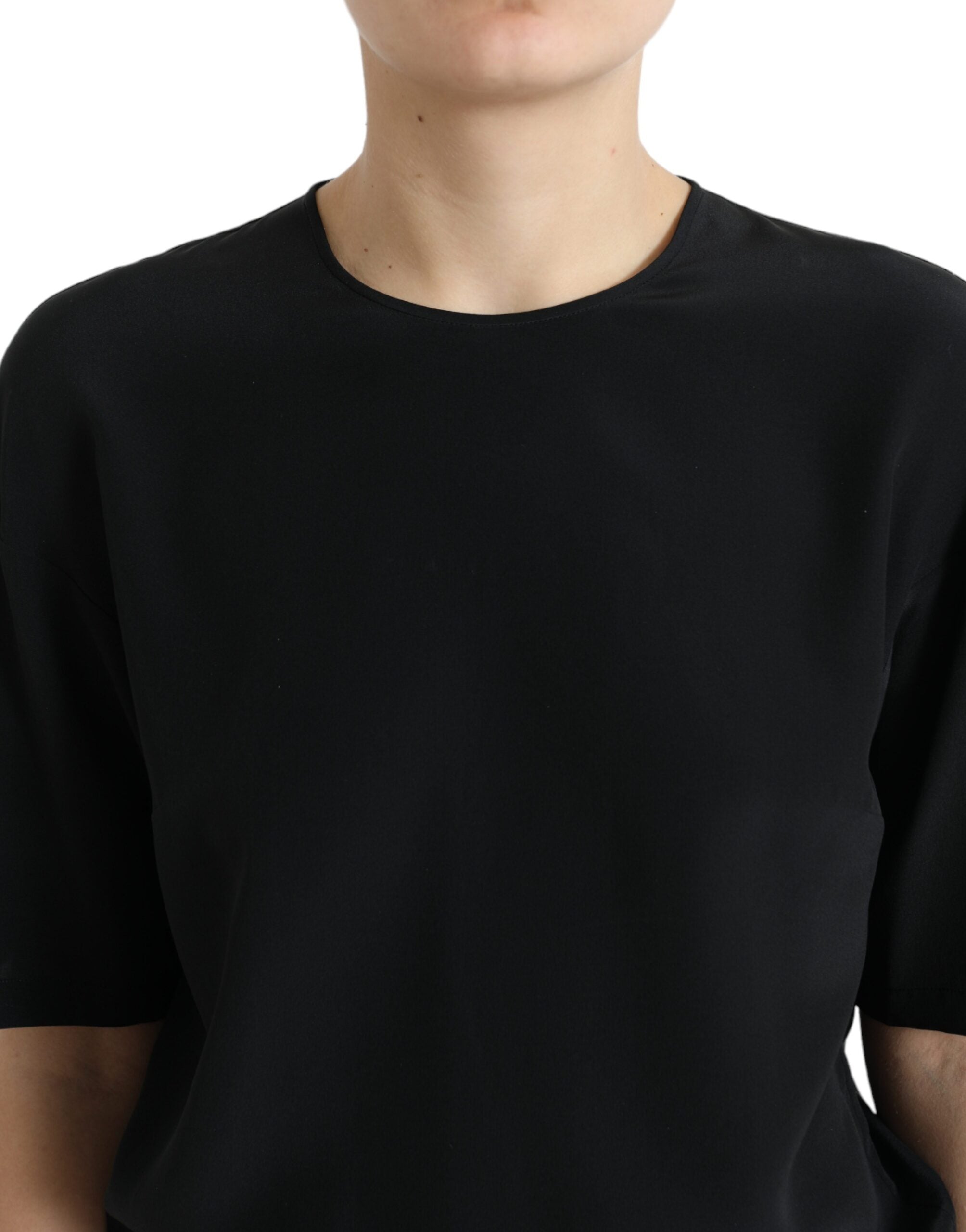 Black silk round neck short sleeve blouse top by Dolce & Gabbana, shown with a smooth, fitted fabric and classic silhouette.