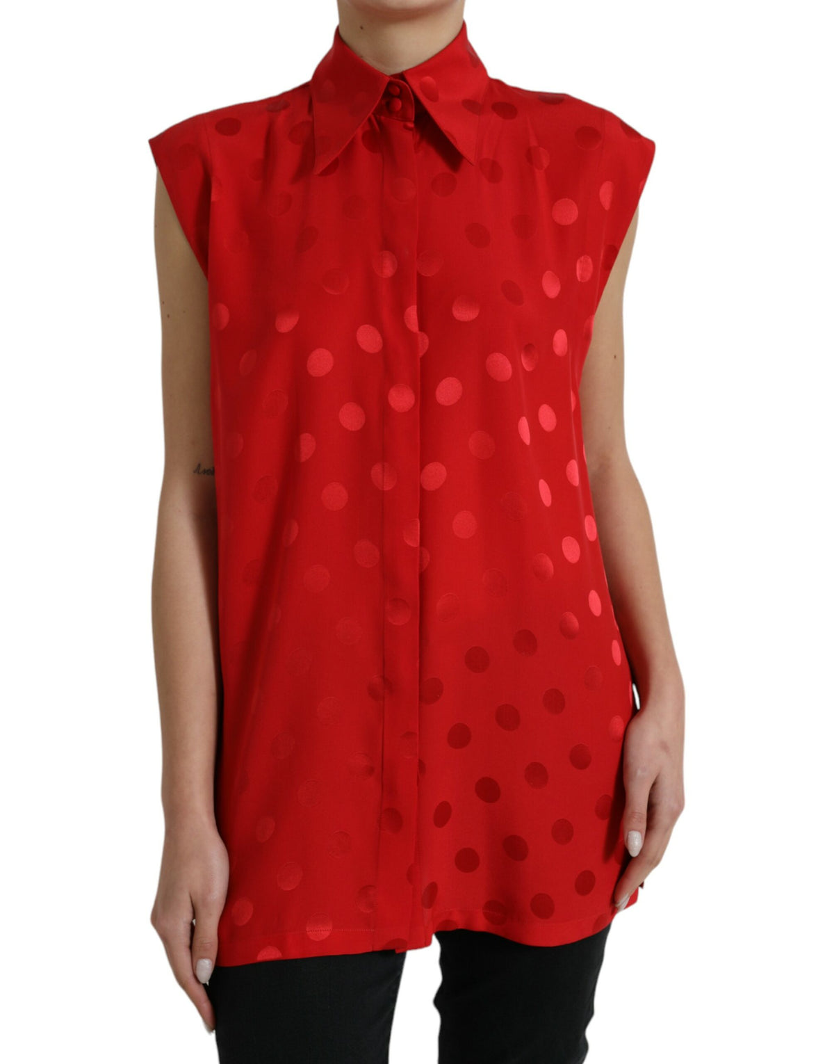 Red polka dot sleeveless blouse with a collared neckline from Dolce & Gabbana, shown on a hanger.