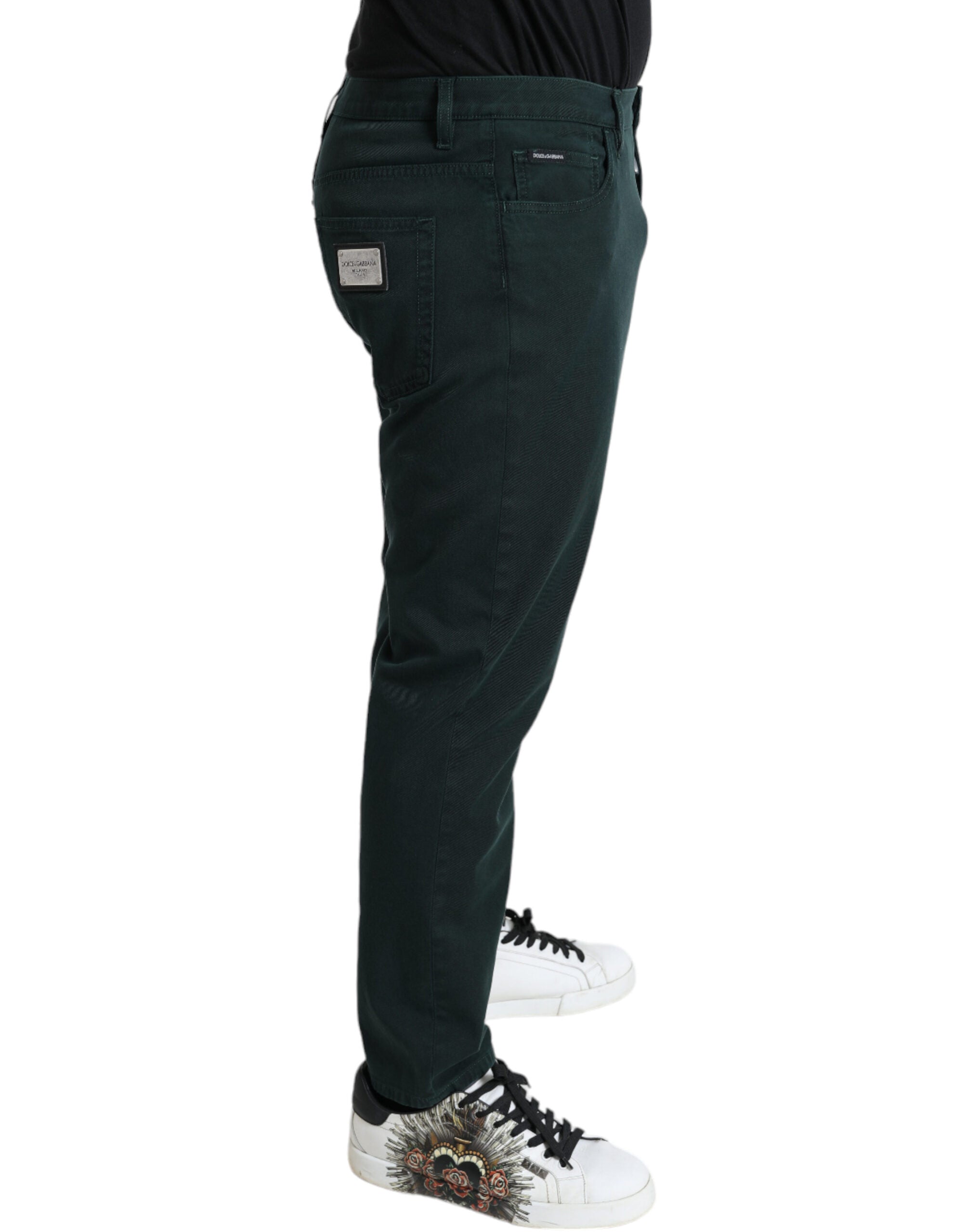 Green cotton stretch skinny men's denim jeans by Dolce & Gabbana, showing close-up of fitted style and fabric details.