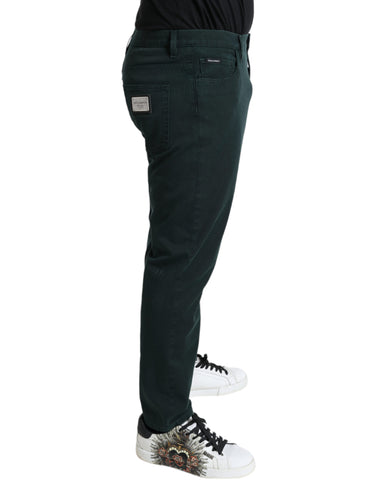 Green cotton stretch skinny men's denim jeans by Dolce & Gabbana, showing close-up of fitted style and fabric details.