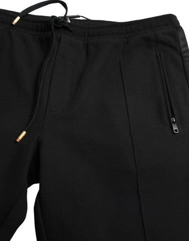 Black cotton skinny jogger sweatpants by Dolce & Gabbana with elastic waistband and tapered fit, casual and stylish for everyday wear.