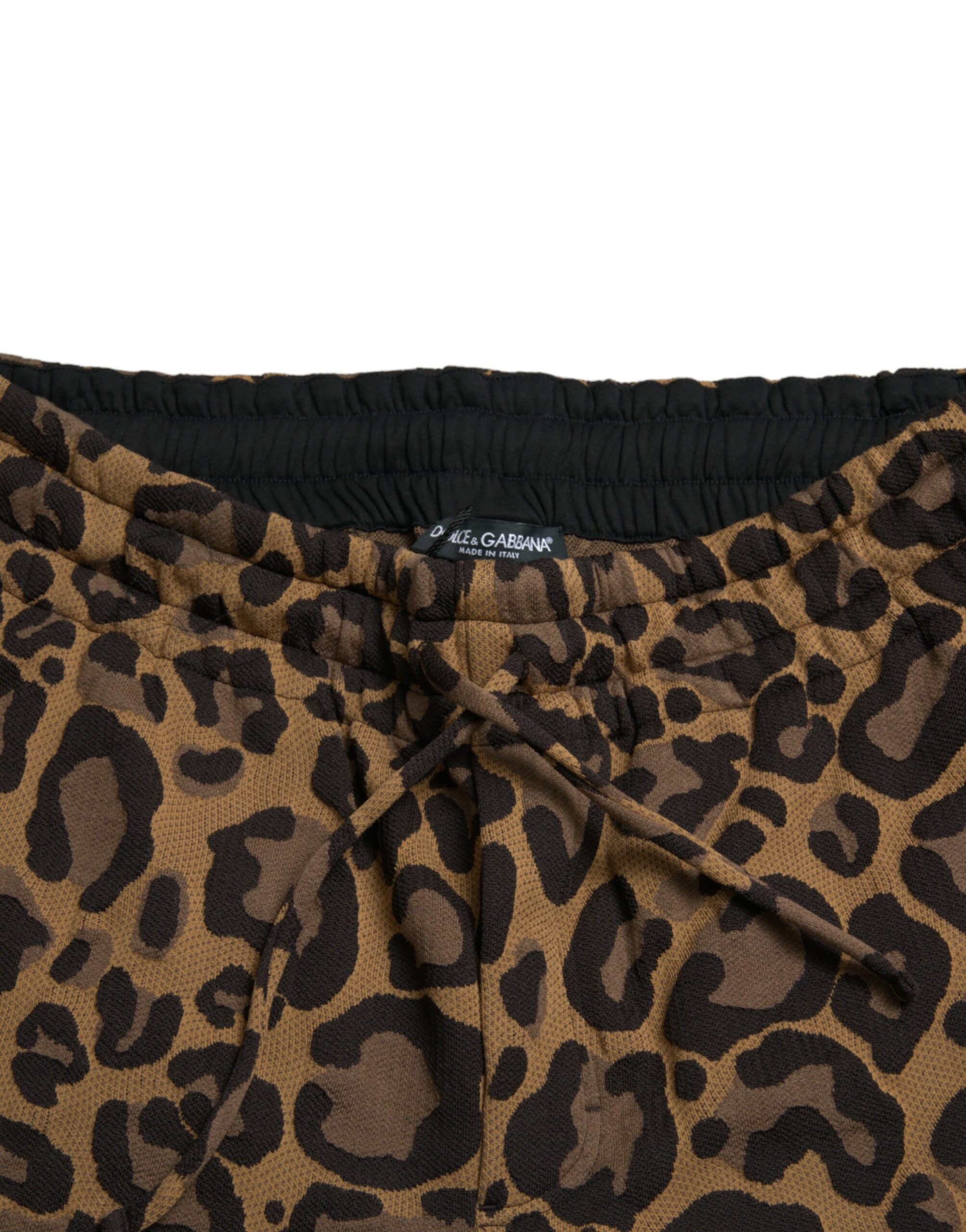 Brown leopard jacquard jogger pants by Dolce & Gabbana with elastic waistband and tapered fit, shown on a model.