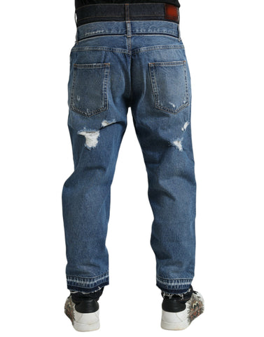 Blue tattered cotton denim jeans for men by Dolce & Gabbana, featuring distressed details and classic fit.