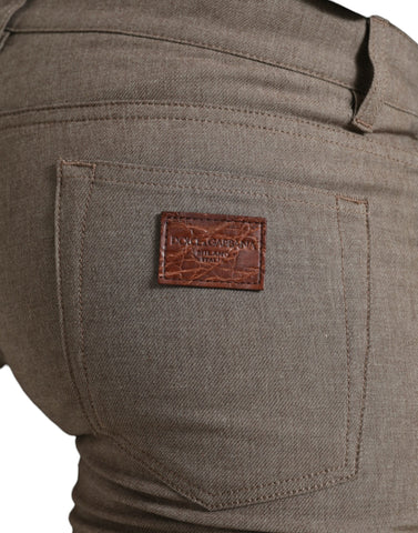 Brown cotton stretch skinny men's pants by Dolce & Gabbana, showing close-up of fitted waistband and fabric texture.