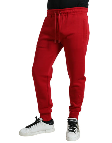 Red cotton blend skinny jogger pants by Dolce & Gabbana, featuring a fitted style and elastic waist for a casual look.