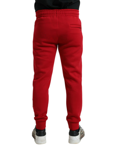Red cotton blend skinny jogger pants by Dolce & Gabbana, featuring a tapered fit and elastic waistband.