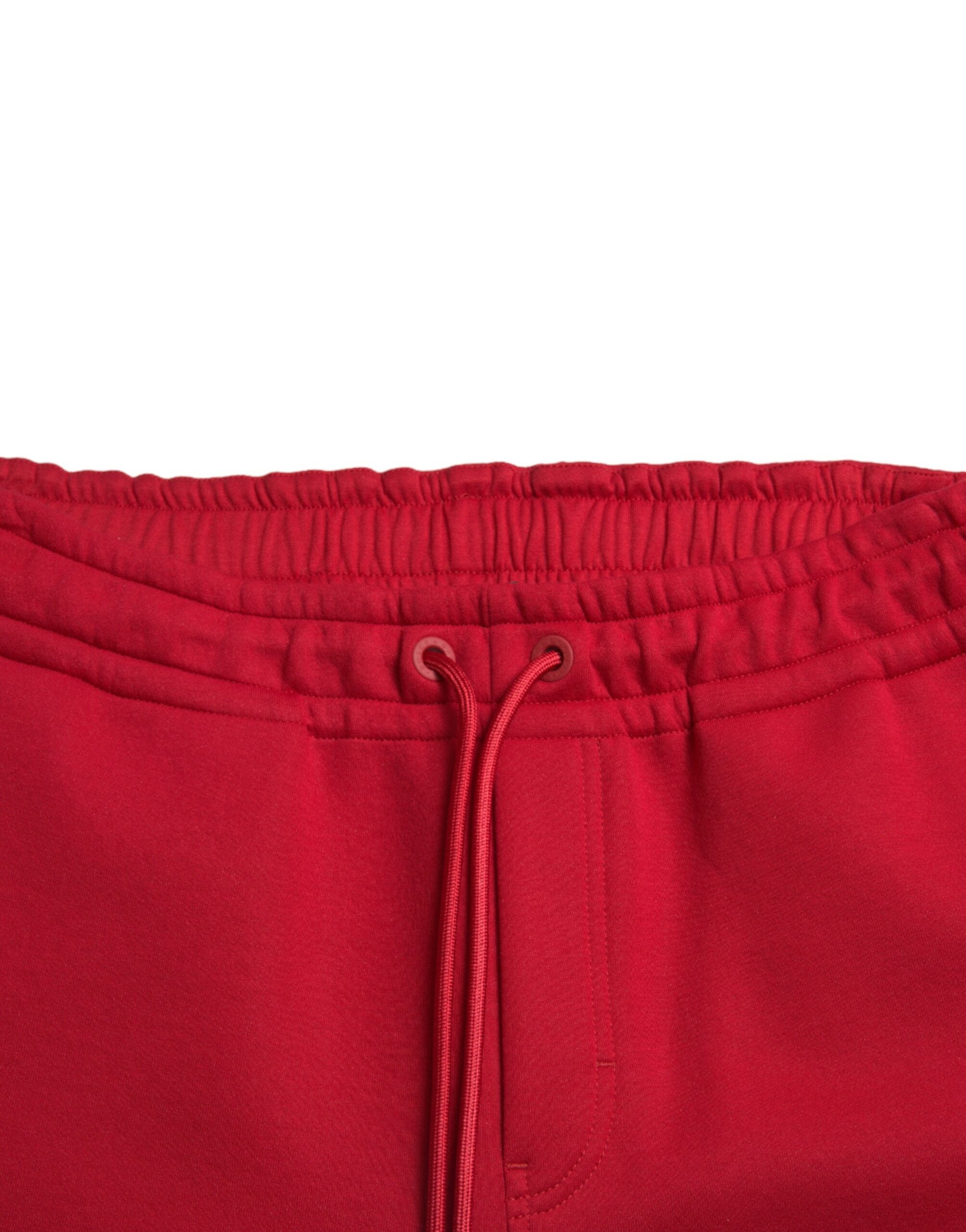 Red cotton blend skinny jogger pants by Dolce & Gabbana, featuring a fitted style and casual yet stylish design.