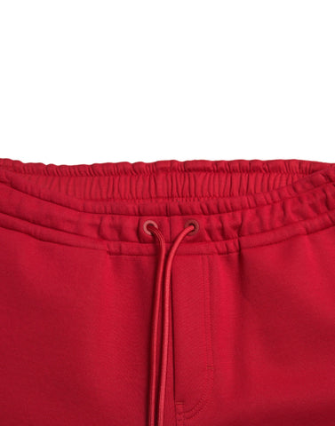 Red cotton blend skinny jogger pants by Dolce & Gabbana, featuring a fitted style and casual yet stylish design.