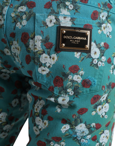 Blue floral print skinny cotton denim pants by Dolce & Gabbana, showcasing a fitted silhouette with vibrant floral patterns.