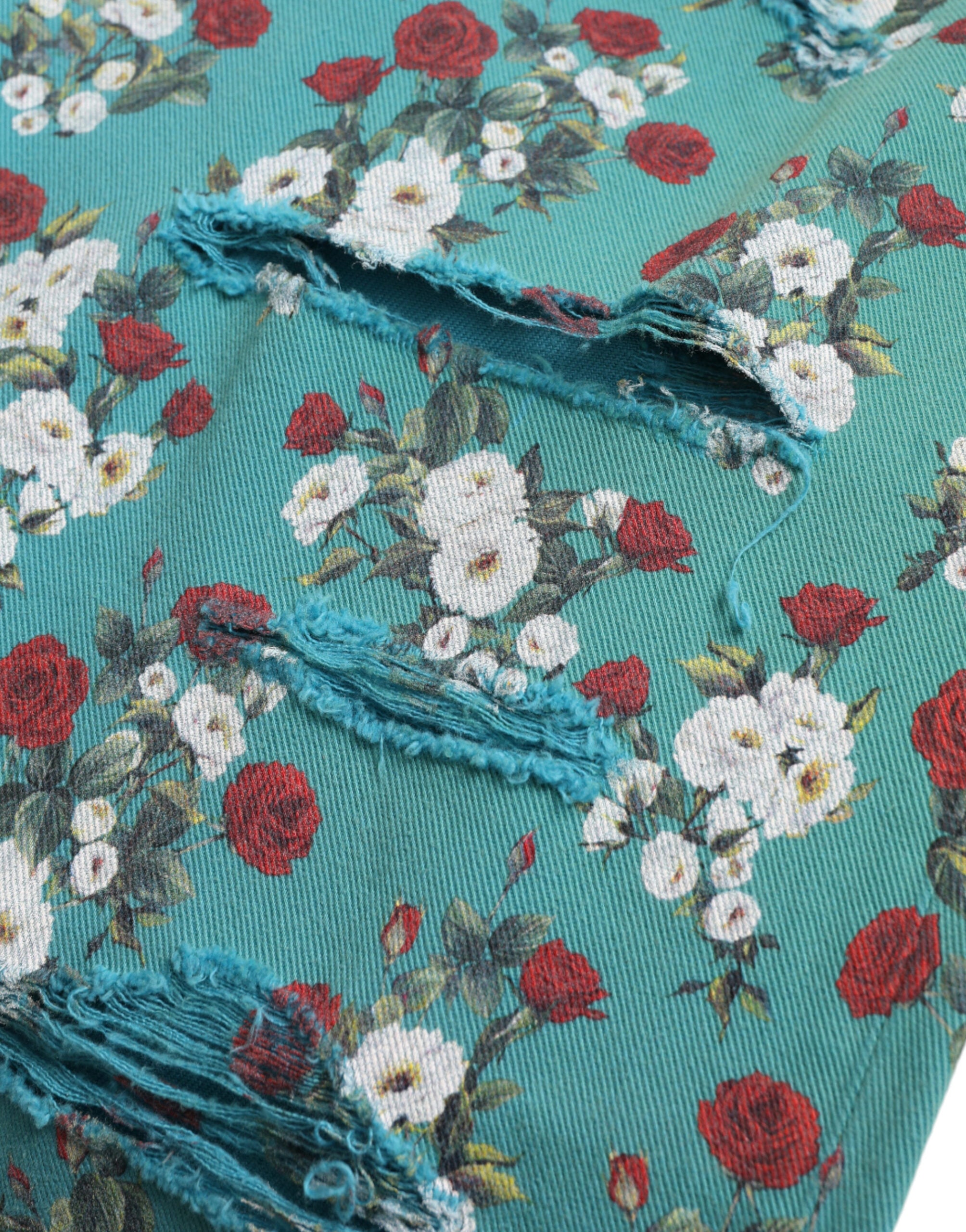 Blue floral print skinny cotton denim pants by Dolce & Gabbana, showcasing vibrant floral pattern and fitted style.