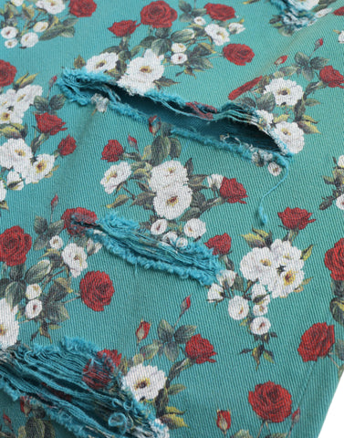 Blue floral print skinny cotton denim pants by Dolce & Gabbana, showcasing vibrant floral pattern and fitted style.