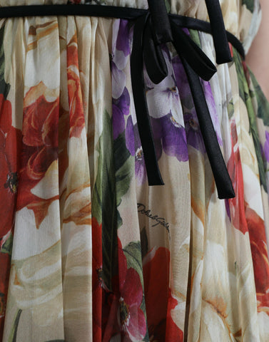 Beige floral sleeveless A-line mini dress by Dolce & Gabbana displayed on a hanger.