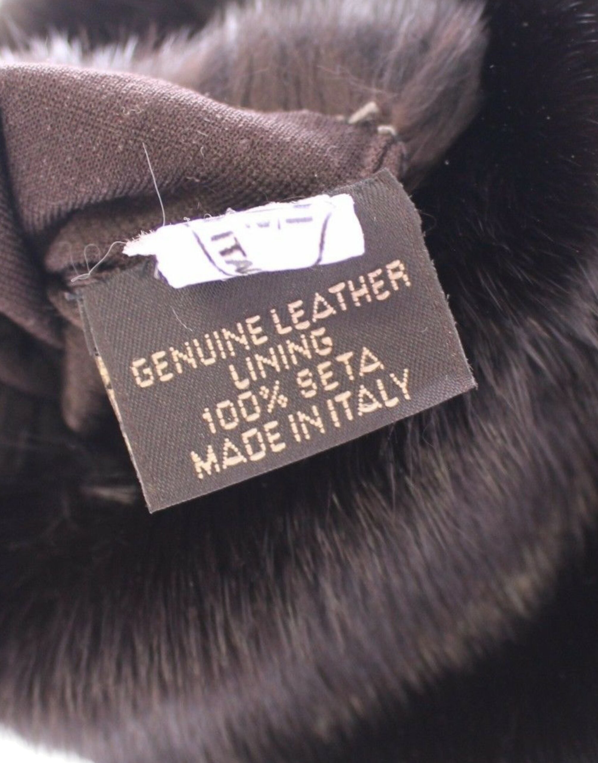 Purple mink fur and goatskin suede leather gloves by Dolce & Gabbana, showcasing soft, luxurious handwear with detailed stitching.