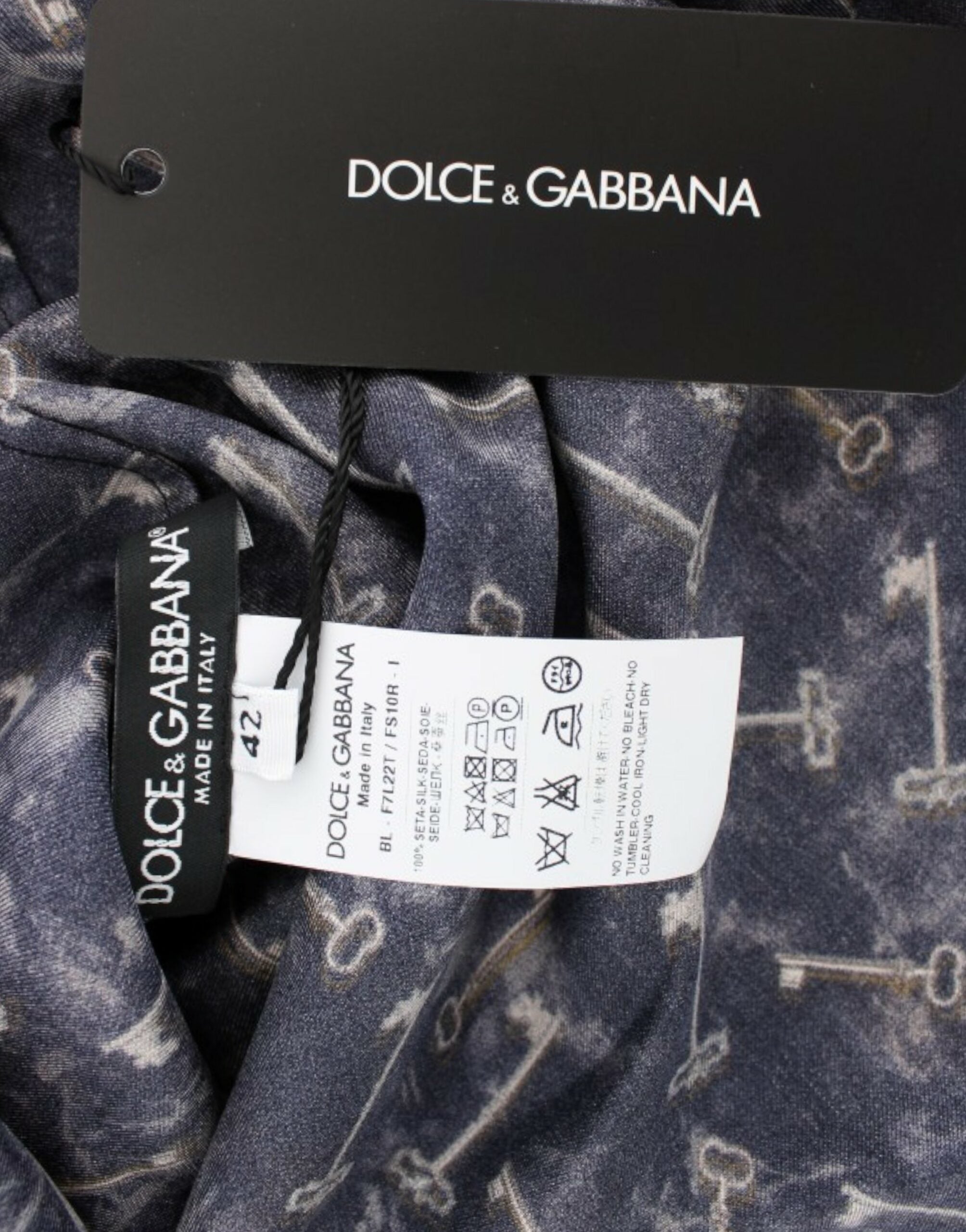 Blue silk blouse with gold key print from Dolce & Gabbana, featuring a elegant, flowing design and detailed pattern.