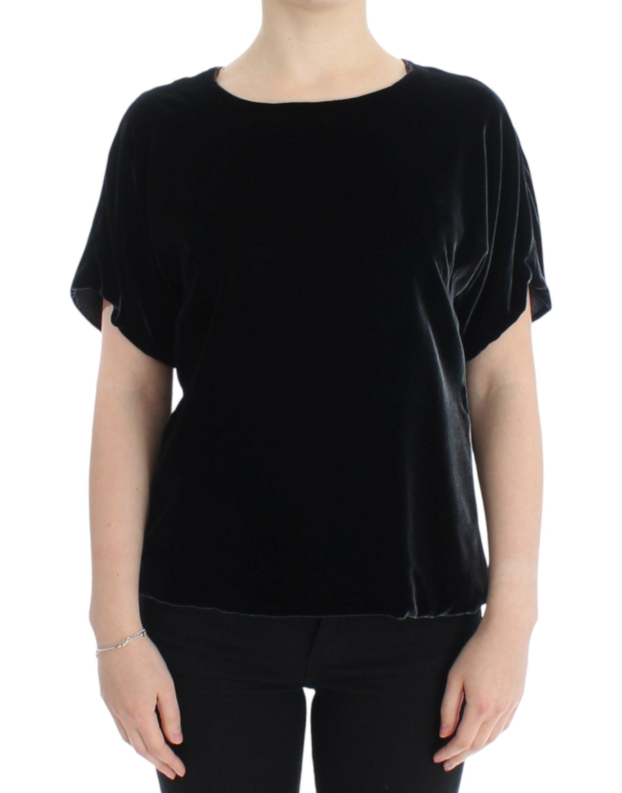 Black velvet shortsleeved blouse by Dolce & Gabbana, close-up showing soft fabric and elegant design details.