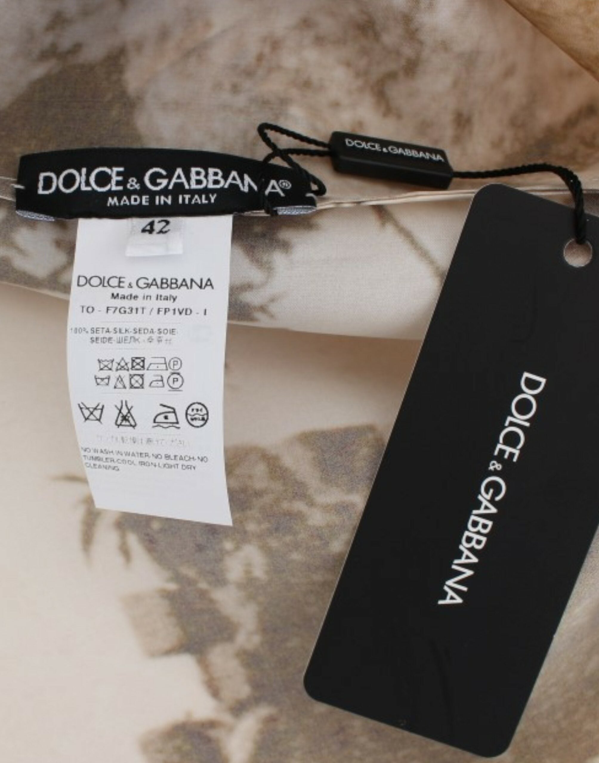 Brown Taormina silk blouse by Dolce & Gabbana, featuring a flowing fit and elegant design, displayed on a hanger.