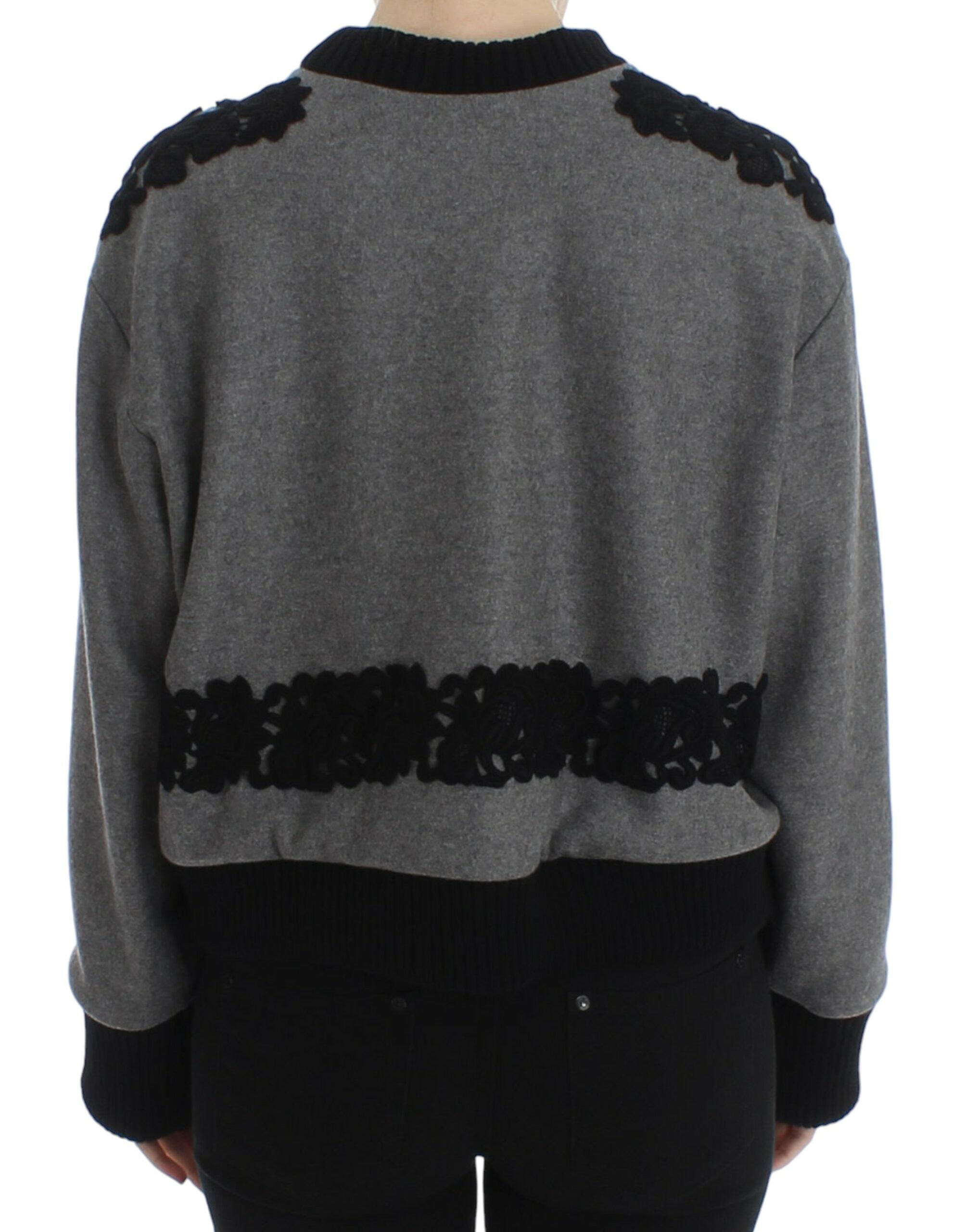 Gray and black lace wool cashmere sweater by Dolce & Gabbana displayed on a hanger with intricate lace details.