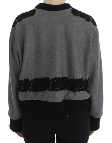 Gray and black lace wool cashmere sweater by Dolce & Gabbana displayed on a hanger with intricate lace details.