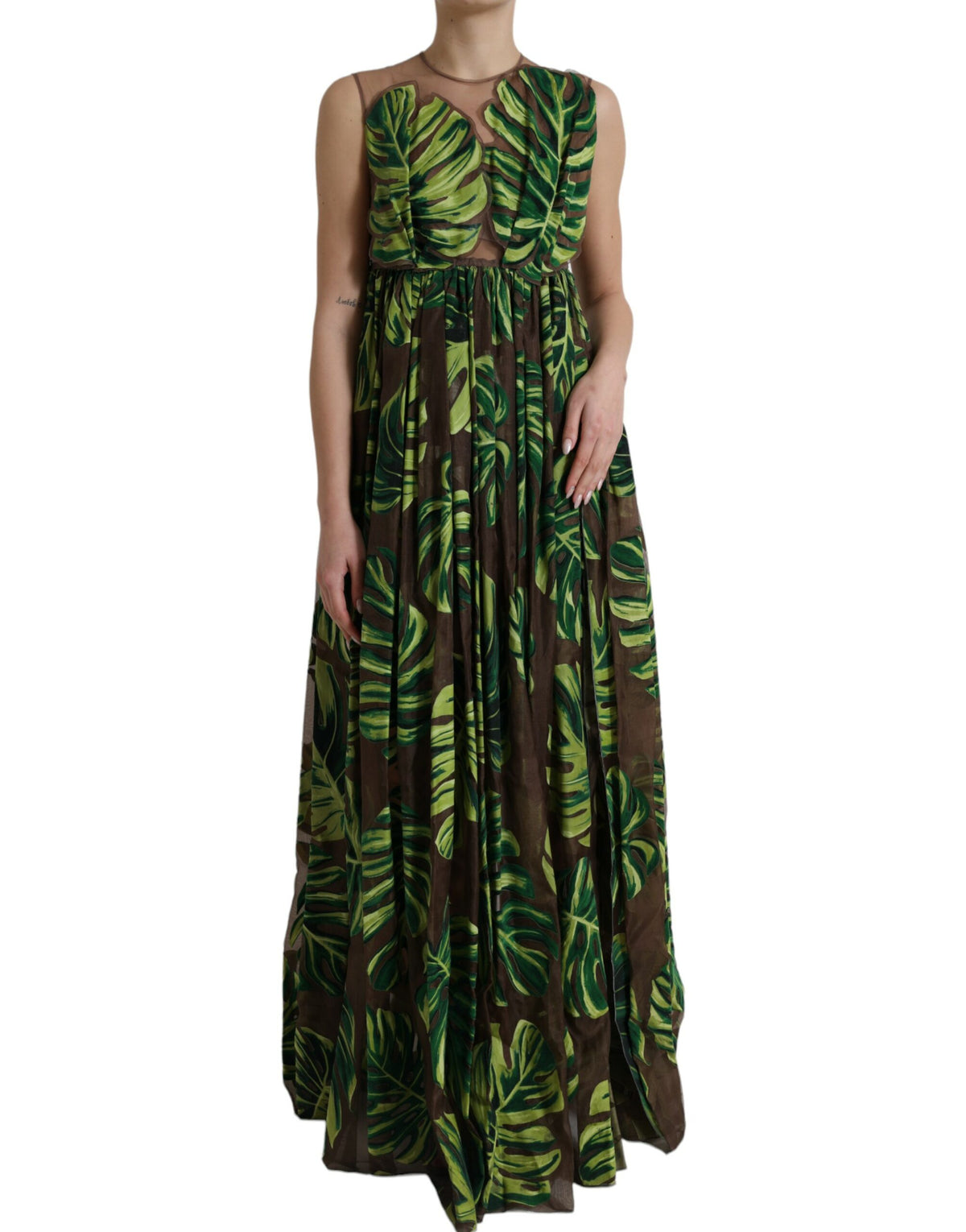 Green banana leaf sleeveless maxi dress by Dolce & Gabbana, flowing fabric with a vibrant botanical print.