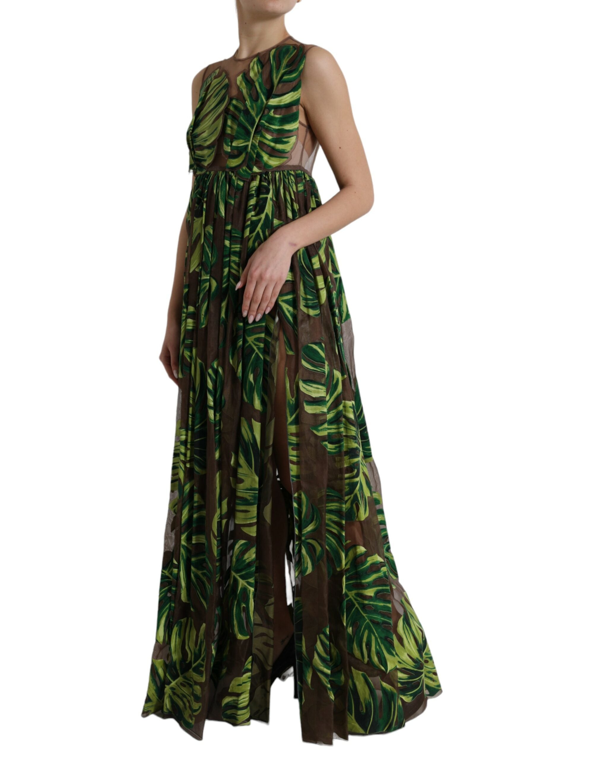 Green banana leaf sleeveless long maxi dress by Dolce & Gabbana displayed on a hanger with flowing fabric and vibrant botanical pattern.