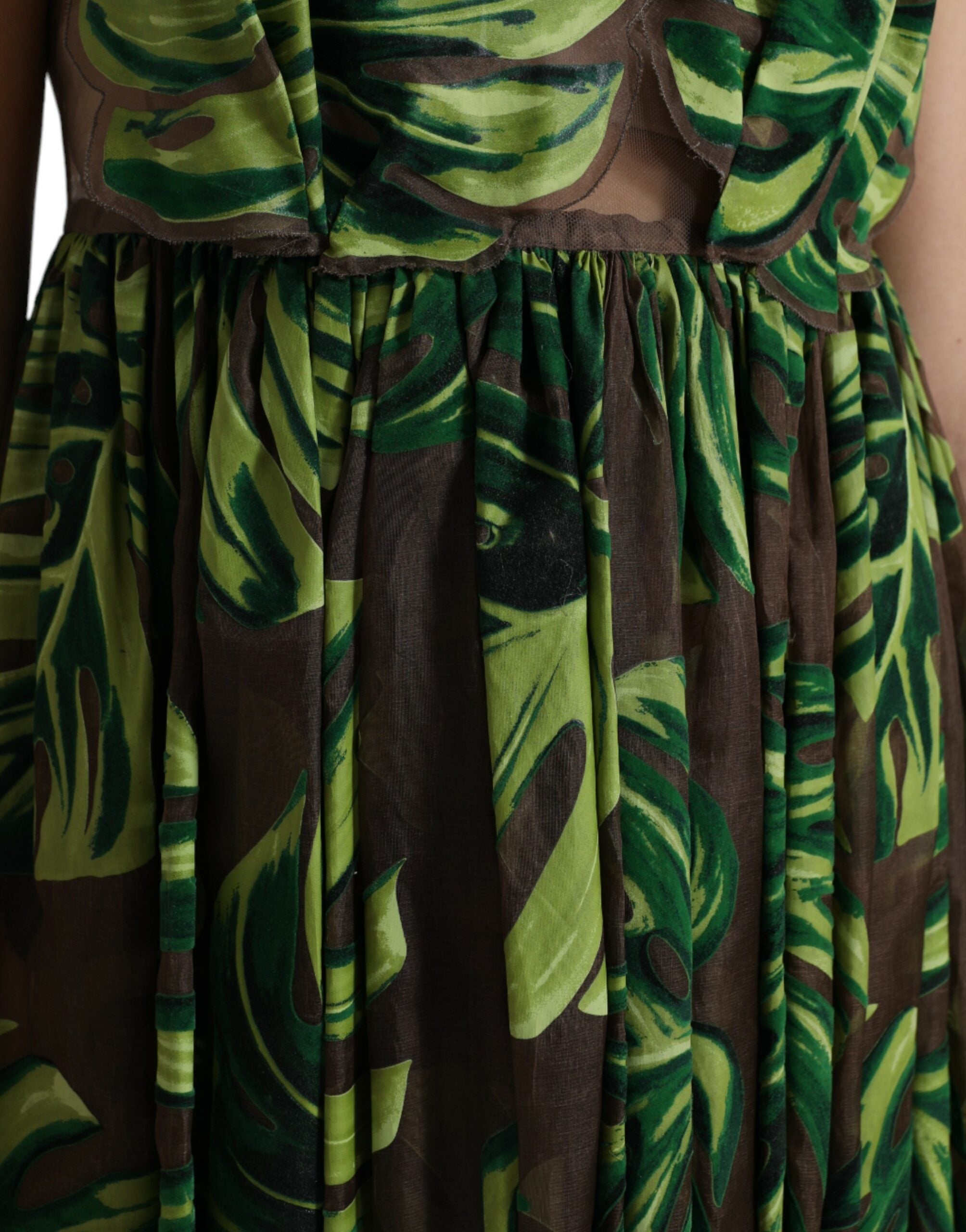 Green banana leaf sleeveless long maxi dress by Dolce & Gabbana, featuring a flowing silhouette and vibrant botanical print.