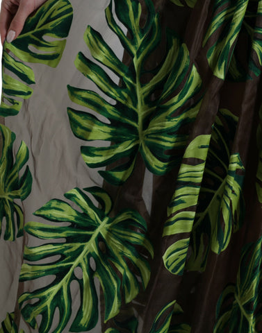 Green banana leaf sleeveless maxi dress by Dolce & Gabbana, flowing fabric with a vibrant tropical print and elegant long silhouette.
