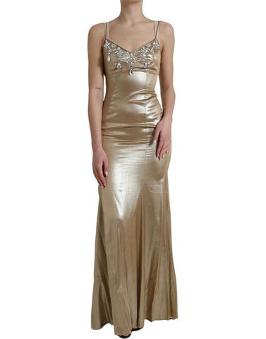 Metallic gold Dolce & Gabbana gown with crystal embellishments, flowing fabric, and elegant design.
