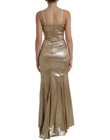 Elegant metallic gold gown with crystal embellishments by Dolce & Gabbana, featuring a flowing fabric and intricate detailing.
