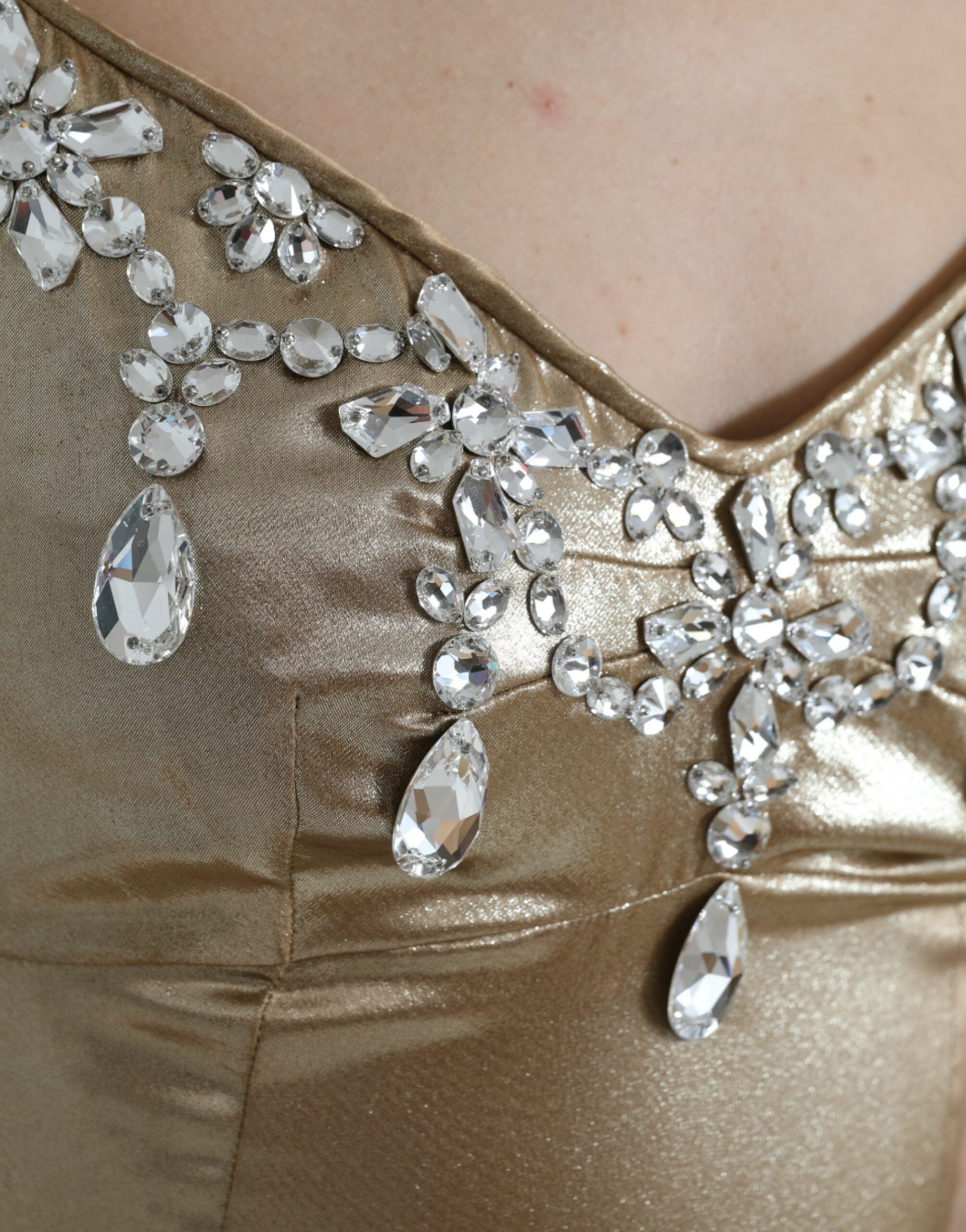 Elegant metallic gold gown dress with crystal embellishments by Dolce & Gabbana, featuring a flowing fabric and intricate detailing.