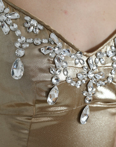 Elegant metallic gold gown dress with crystal embellishments by Dolce & Gabbana, featuring a flowing fabric and intricate detailing.