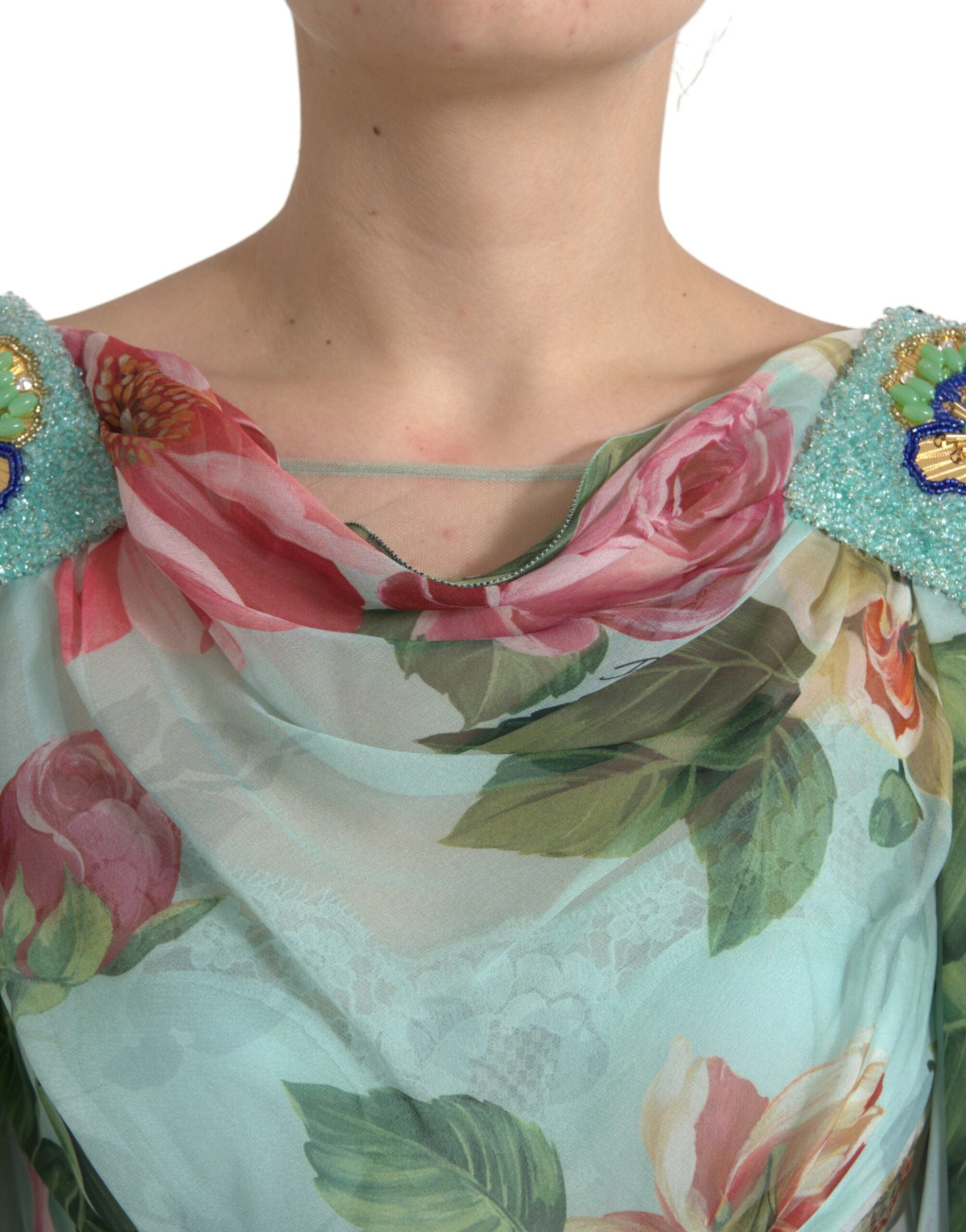 Blue floral print tiered long maxi dress by Dolce & Gabbana displayed on a hanger, showcasing its flowing fabric and vibrant pattern.