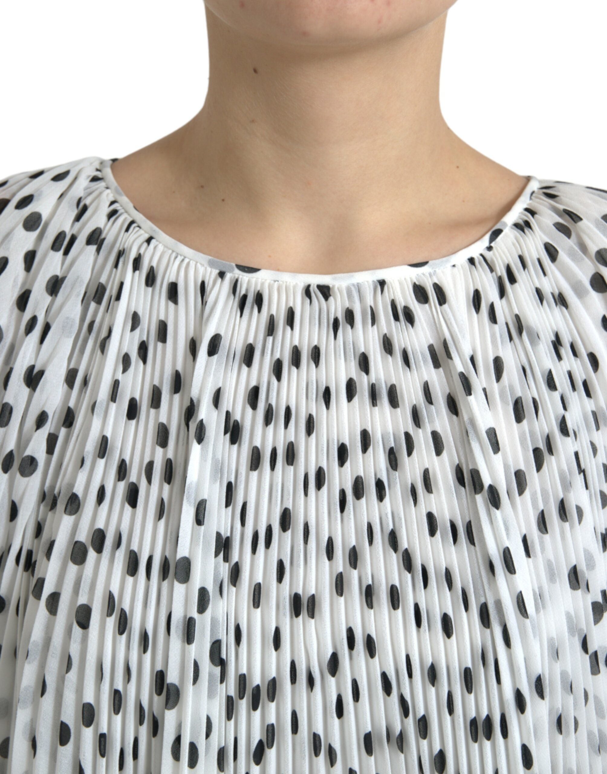 White polka dot A-line pleated maxi dress by Dolce & Gabbana, featuring a flowing silhouette and elegant design.